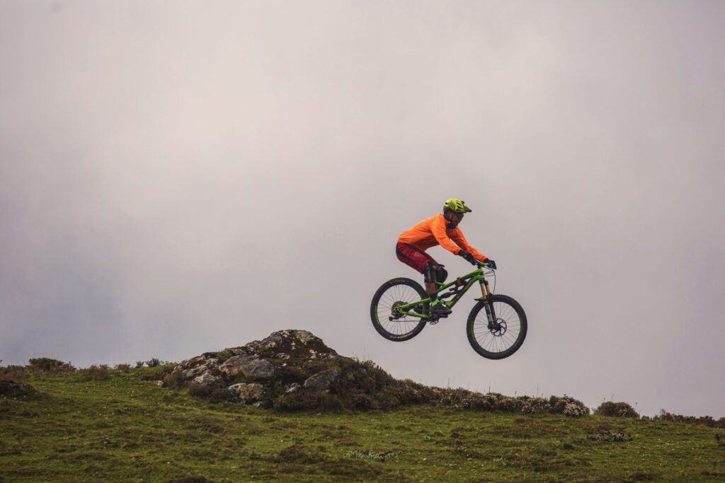 Full airtime above a grassy ridge
