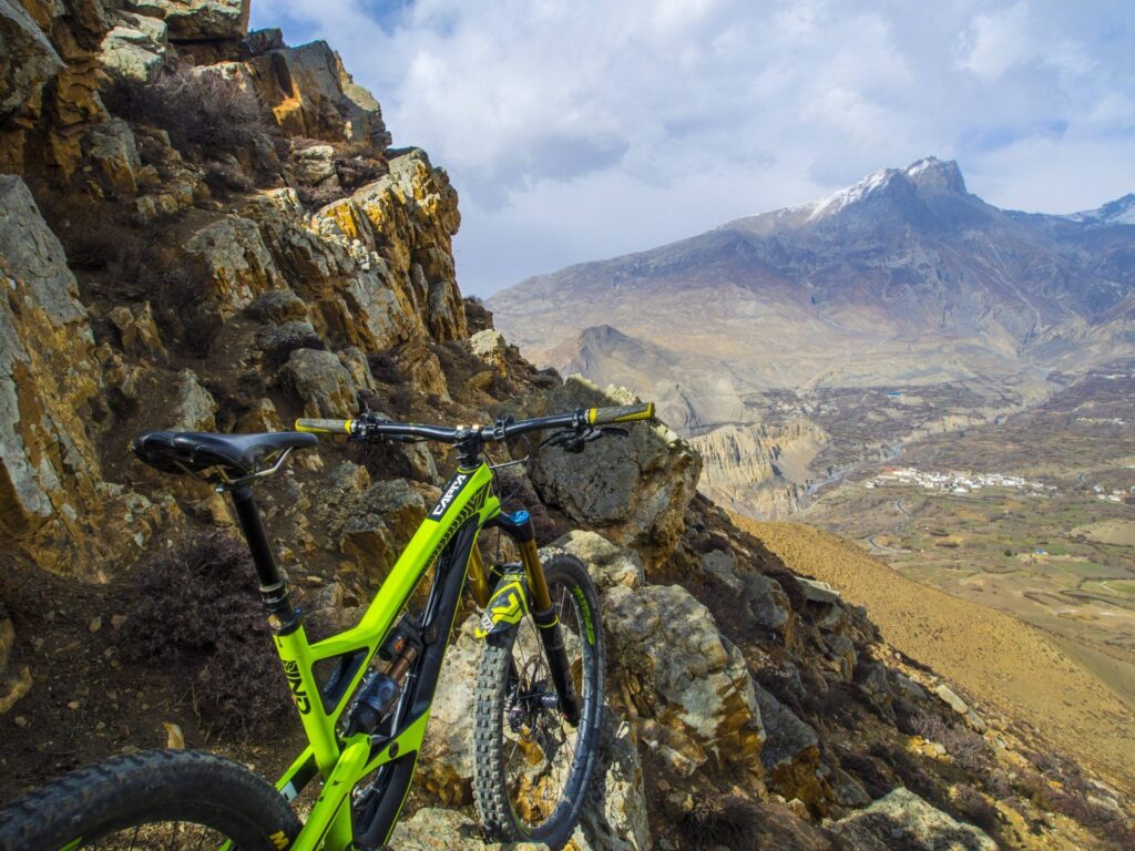 An enduro bike propped on Himalayan rock