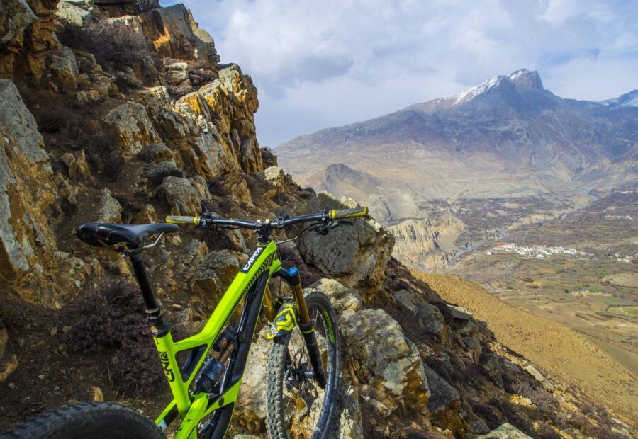 An enduro bike propped on Himalayan rock