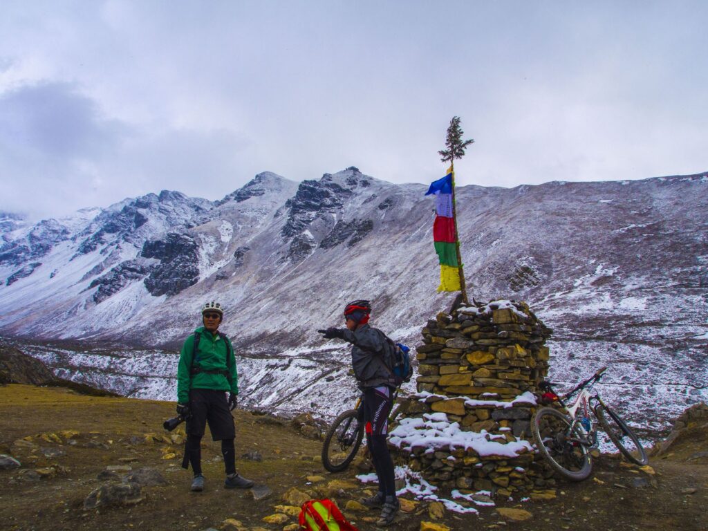 A chorten strung with prayer flags