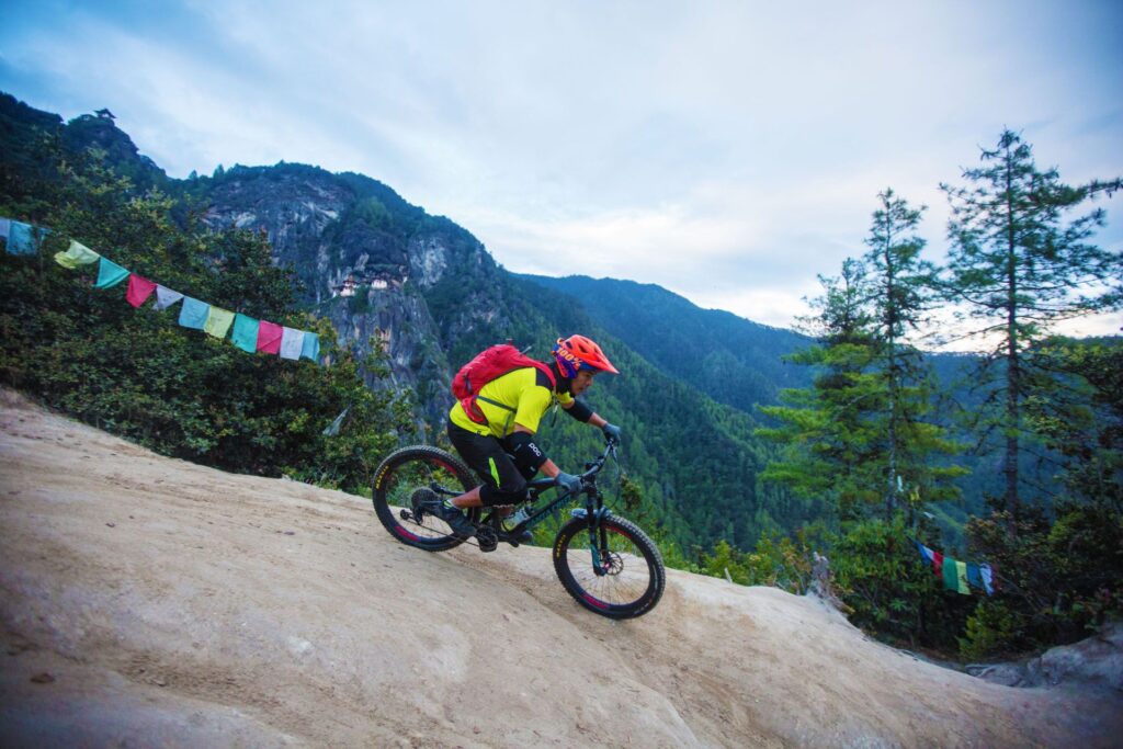 Riding beneath prayer flags near Tiger's Nest
